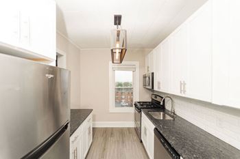 A kitchen with granite counter tops and stainless steel appliances